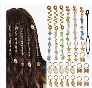 Detail of golden spiral hair clips and natural stone pendants for braided hairstyles