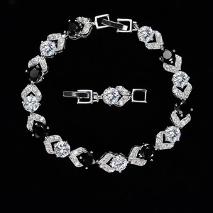 Hip hop style silver bracelet featuring alternating black and white zircon stone inlay