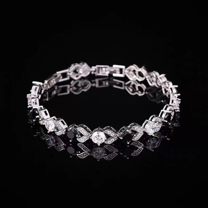 Macro shot of hip hop tennis bracelet with black and white zircon stones on black mirror