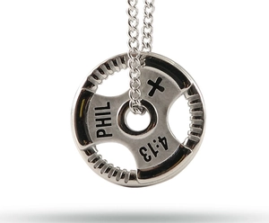 Macro-opname van zilveren halterplaat ketting met gegraveerde PHIL 4:13 religieuze tekst
