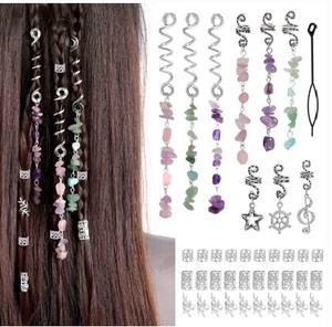 Macro view of dreadlock hair accessories set with natural stones and silver charms