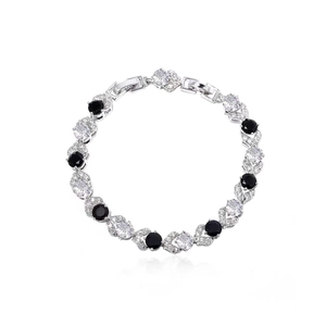 Detail of silver-tone bracelet featuring black stones and white cubic zirconia with claw setting