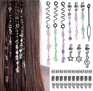 Detail of hair braid set with natural stones and metal charms for dreadlock styling