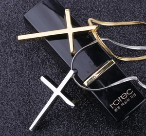 Detail view of minimalist gold and silver stainless steel cross pendants with chains