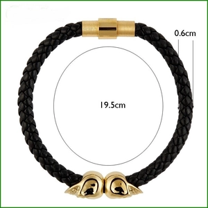 Detail of black woven leather bracelet featuring gold skull clasp and size annotations