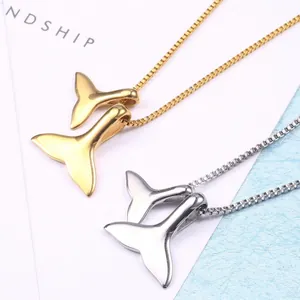 Minimalist whale tail pendant necklace in gold and silver finish with polished box chain
