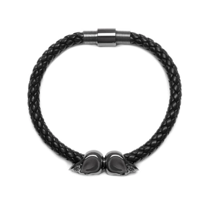 Men's punk leather bracelet with double skulls and magnetic clasp on white background