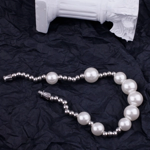 Detail of pearl bead bracelet with silver metal spacers and secure screw clasp