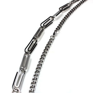 Detailed view of polished silver paperclip and curb chains for a modern minimalist look