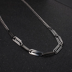 Minimalist titanium steel paperclip necklace with industrial design on black background