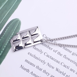 Unisex silver titanium steel sweater necklace featuring a bitten chocolate bar pendant