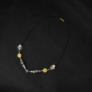 Hip hop beaded necklace with smiley face, skulls, dice and butterfly charms on black cord