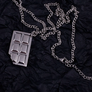 Punk style stainless steel necklace featuring a unique bitten chocolate bar pendant