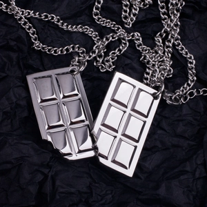 Detailed macro view of silver bitten chocolate pendants on steel sweater chains
