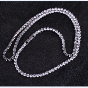 Detail showing high-quality cubic zirconia stones in a four-prong silver tennis chain