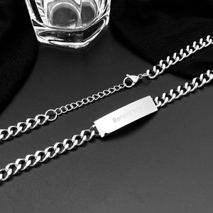 Minimalist silver titanium steel necklace with Serendipity engraved bar on black background