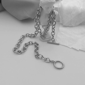 Detail view of bold stainless steel link chain necklace featuring a classic OT toggle clasp