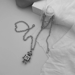 Detail of vintage hip hop robot pendant showing K18L engraved steel tag and chain