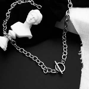 Detailed close-up of a silver cuban chain necklace with a stylish OT toggle clasp