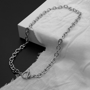 Macro detail of silver OT toggle clasp on titanium steel chain necklace for a trendy look