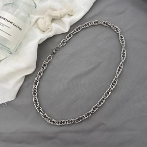 Minimalist thick silver metal chain necklace with lobster clasp in a flat lay setup