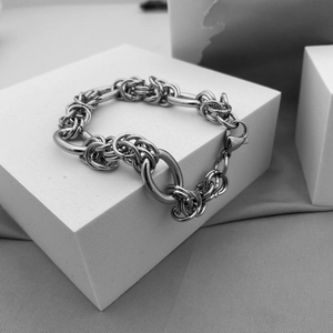 Minimalist stainless steel chain bracelet with lobster clasp on geometric platform