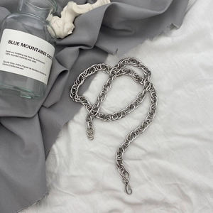 Detail of chunky silver metal chain necklace with lobster clasp and polished finish