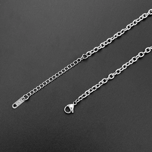 Detail view of O-chain necklace with lobster clasp and K18 engraved extension tag