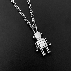 Macro shot of silver hip-hop robot pendant with intricate dot details on an O-chain