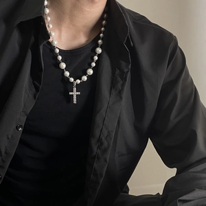 Close-up of pearl cross necklace with square rhinestones on male model neck