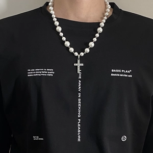 Detail of pearl beaded necklace with sparkling crystal encrusted silver cross pendant