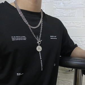 Close-up of titanium steel double-layer necklace with sad face pendant and T-clasp