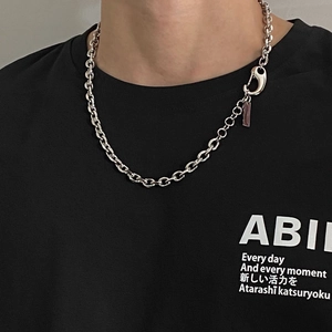 Close-up of silver punk O-chain necklace with lobster clasp on black t-shirt