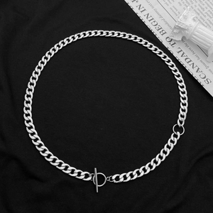 Detailed close-up of a silver Cuban chain necklace featuring a stylish toggle clasp fastener