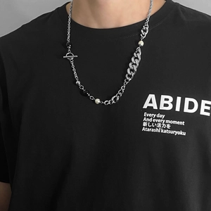Close-up of mixed Cuban chain necklace with black and white pearls and T-bar toggle clasp