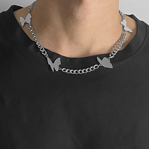 Silver butterfly charm necklace with punk style chain links on a black t-shirt