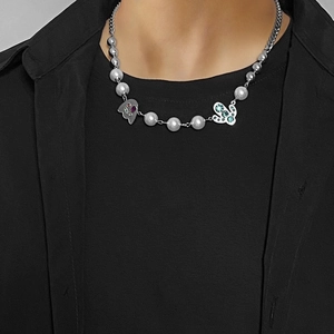 Detail of pearl and titanium steel necklace with ghost and rhinestone butterfly charms