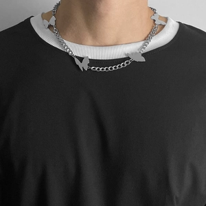 Detail of butterfly necklace on model with four silver butterfly pendants and curb chain
