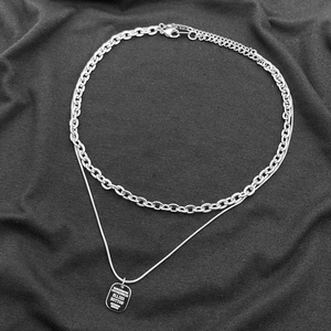 Détail du collier industriel double épaisseur avec pendentif rectangulaire gravé argent