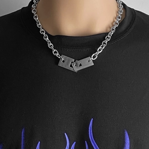 Detail of a chunky titanium steel chain necklace with an interlocking square buckle