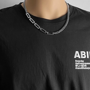 Detail of silver-tone titanium steel Cuban link necklace with modern geometric splicing