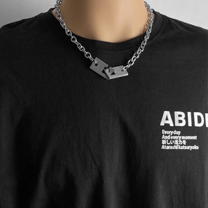 Close-up of industrial chunky silver metal chain with interlocking rectangular pendants