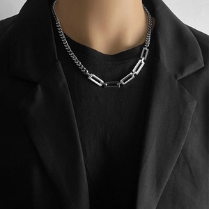 Close-up of Cuban link stitching and geometric hollow links on a silver titanium necklace