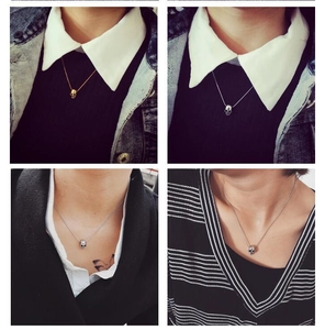 Detail showing vintage skull pendants in gold and silver finish on a steel chain