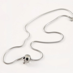 Gothic skull necklace with black stone eyes on sleek silver steel snake chain