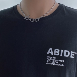 Detailed view of silver titanium steel chain necklace with OT buckle on a male model