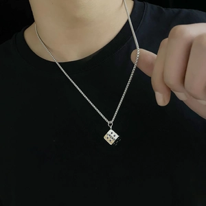 Unisex silver stainless steel dice pendant necklace with purple dots on black shirt