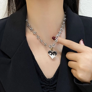 Silver heart flame pendant necklace with chunky chain shown on a black suit model neck