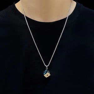 Close-up of a silver stainless steel dice pendant on a round link chain for unisex style