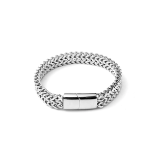 Macro view of double wheat chain weaving and polished buckle on stainless steel bracelet
